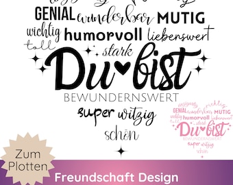 May include: A black and white graphic design with the words "Du bist" in a stylized font, meaning "You are". Surrounding the central text are words like "unique", "wonderful", and "strong". The design includes a small starburst and a heart.