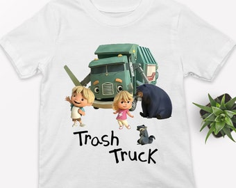 May include: White t-shirt with a green trash truck, two children, and a bear. The text "Trash Truck" is written in black below the image.