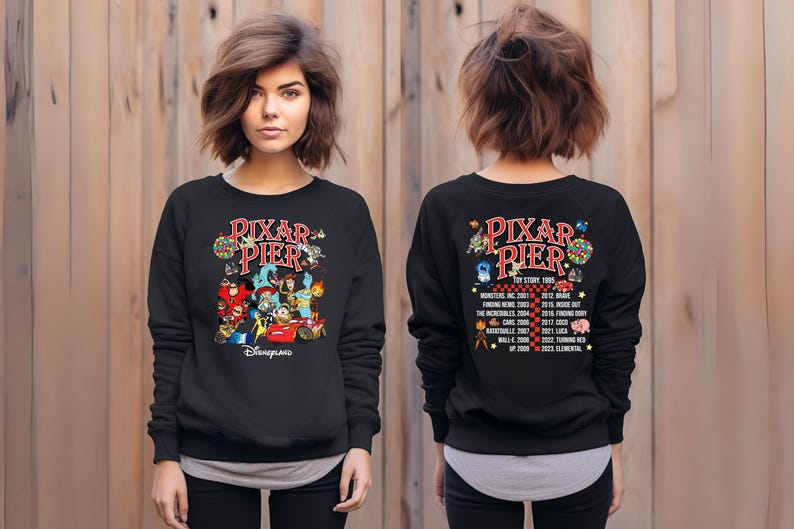 May include: Black sweatshirt with a colorful graphic of Pixar characters and the text "Pixar Pier" and "Disneyland". The back of the sweatshirt features a list of Pixar movies and their release years.