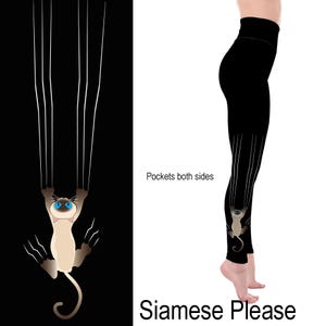 May include: Black leggings with a Siamese cat design. The cat is depicted with blue eyes and is hanging from white claw marks. The text "Siamese Please" is at the bottom. The leggings have pockets on both sides.