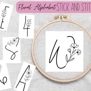 Puede incluir: Un conjunto de patrones de bordado que presentan las letras E, S, A, U y el número 4. Cada letra está decorada con un diseño floral simple. Las letras se muestran en tarjetas blancas y un aro.