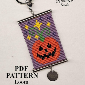 May include: A rectangular beaded keychain featuring a woven pumpkin design on a purple background with yellow star accents. The piece is held by a silver metal keyring and includes a small round metal tag. Text reads: Kobzar beads, PDF PATTERN Loom, based on Miyuki delica 11/0, BTM-43.