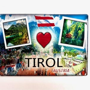 Könnte beinhalten: Ein rechteckiger Magnet mit einer Collage aus Bildern und Text. Er zeigt ein rotes Herz, die österreichische Flagge und zwei gerahmte Landschaftsfotos. Das Wort "TIROL" ist prominent dargestellt, darunter "AUSTRIA".
