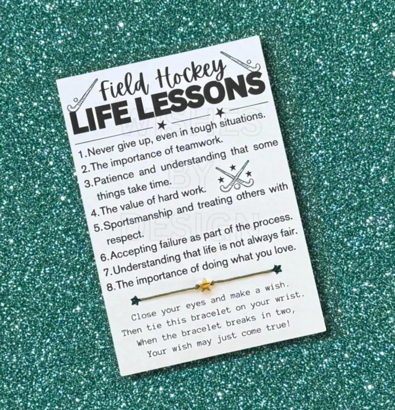 May include: A white card with the text "Field Hockey Life Lessons" and a list of life lessons. A gold star charm bracelet is attached. The card includes instructions to make a wish and tie the bracelet.