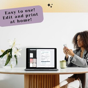 May include: A person sitting at a table with a laptop open to a document. The laptop is on a white table with a vase of white flowers. The person is holding a smartphone in their hand. The text on the laptop screen reads "Easy to use! Edit and print at home!"