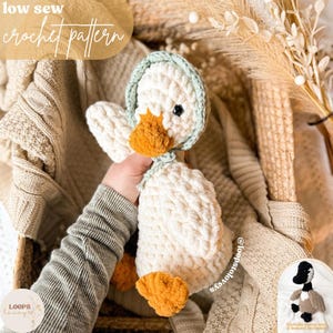 May include: A crocheted duck doll with a white body, orange beak and feet, and a pale green bonnet. The text "low sew crochet pattern" is at the top. The doll is held in a person's hand.
