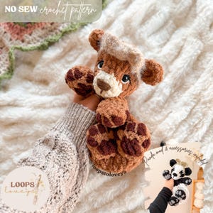 May include: A crocheted brown and tan bear with a cream-colored muzzle and a light brown hat. The text "NO SEW crochet pattern" is at the top. A smaller image shows a panda bear with accessories. The text "Panda mod & accessories included!" is also visible.