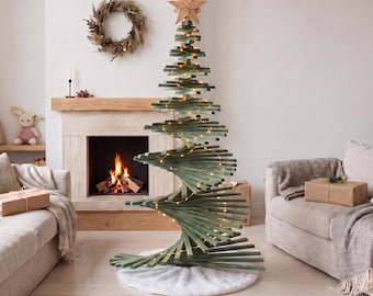 May include: A spiral-shaped Christmas tree constructed from horizontal green wooden slats, topped with a natural wood star. The tree is illuminated by thin string lights and stands on a round white faux fur base in a living room setting.
