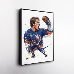 May include: A framed wall art print featuring a stylized illustration of a hockey player wearing a blue and orange jersey with the number 5. The player is shown in two poses, one celebrating with a raised fist and the other skating with a hockey stick.