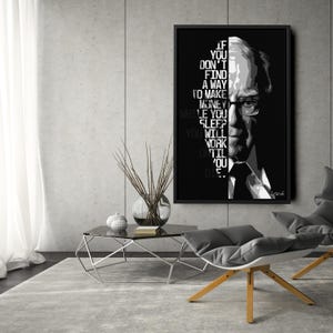 May include: Black framed wall art with a grayscale portrait and text. The text reads: "If you don't find a way to make money while you sleep, you will work until you die."