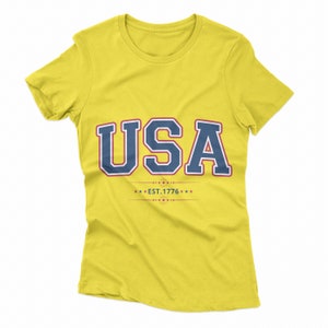 May include: Yellow t-shirt with a navy blue and white USA graphic and the text "EST. 1776" in red.