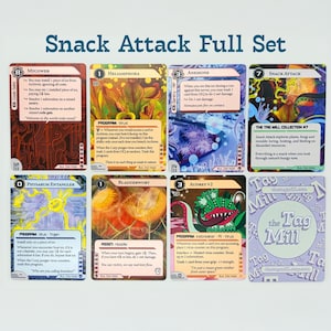 May include: A complete set of "Snack Attack" trading cards. The cards display vibrant illustrations of plants and creatures, accompanied by text. The set includes cards such as "Mycowan", "Hellamphora", and "Anemone". The Tag Mill logo is also present on one of the cards.