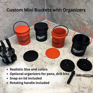 May include: Custom mini buckets with organizers in orange and black. The image shows several small buckets with handles, lids, and organizers for pens and drill bits. The text on the buckets reads "Milwaukee".