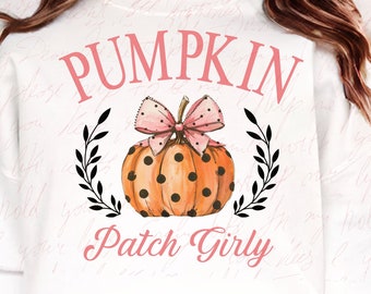 May include: White sweatshirt with a pink and black pumpkin design. The pumpkin has polka dots and a pink bow. The text "Pumpkin Patch Girly" is written below the pumpkin.