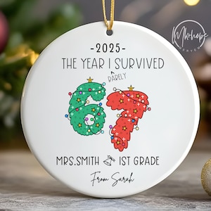 May include: Round white ceramic Christmas ornament with gold hanging string. The ornament has the text "-2025- THE YEAR I SURVIVED DARELY" above the numbers "67" decorated with Christmas lights. Below the numbers is "MRS.SMITH 1ST GRADE From Sarah".