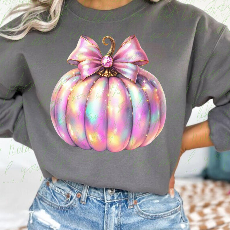 May include: A pink iridescent pumpkin with a large pink bow and a gold stem. The pumpkin has a sparkly, holographic finish.
