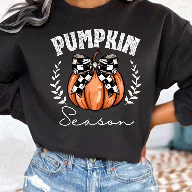 May include: Black sweatshirt with a white graphic of a pumpkin with a checkered bow and the text "Pumpkin Season".