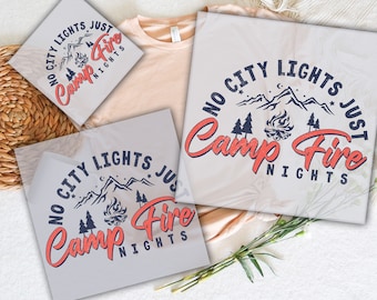 May include: Two heat transfer designs for apparel, featuring the text "No City Lights Just Camp Fire Nights" in a blue and red colour scheme with a mountain and campfire graphic.