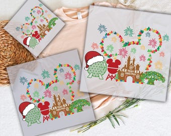 May include: A set of three iron-on transfers featuring a Mickey Mouse silhouette with a Christmas tree, fireworks, and a gingerbread castle. The transfers are ready to press onto clothing or other fabric items. The text "Merry Christmas" is included on the castle.