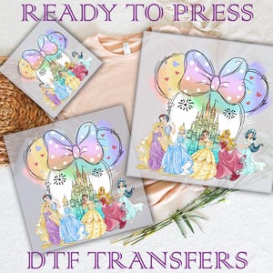 May include: A digital transfer design featuring a pink and blue bow with white polka dots, a castle, and Disney princesses. The design is ready to press onto a t-shirt or other fabric.