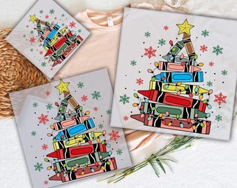 May include: DTF transfers featuring a Christmas tree design made of crayons, adorned with string lights and a star. The transfers are on a light gray background with snowflakes and the text "READY TO PRESS" and "DTF TRANSFERS".