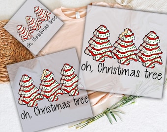 May include: DTF transfers featuring a Christmas tree design with red, white, and green accents. The phrase "oh, Christmas tree" is printed below the trees. The words "READY TO PRESS" and "DTF TRANSFERS" are also visible.