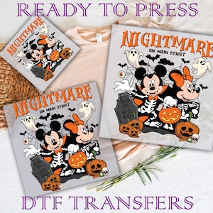 May include: DTF transfers featuring a Halloween-themed design with Mickey and Minnie Mouse dressed as skeletons. The design includes pumpkins, ghosts, and the text "Nightmare on Main Street". The words "Ready to Press" and "DTF Transfers" are also visible.