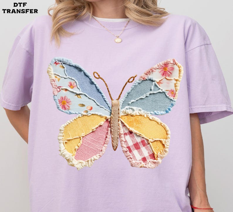 May include: A light purple t-shirt featuring a large, colorful butterfly applique. The butterfly has wings made of patchwork fabric in shades of blue, yellow, pink, and red, with floral and gingham patterns. The text "DTF TRANSFER" is in the upper left corner.