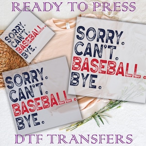 May include: Three iron-on transfers with the text "Sorry. Can't. Baseball. Bye." in blue and red lettering on a white background. The transfers are ready to press.