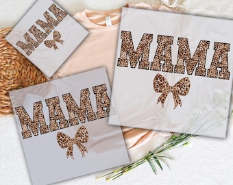 May include: Three white t-shirts with the word "MAMA" printed in brown leopard print letters. The word is centered on each shirt. The shirts are ready to press. The text "READY TO PRESS" and "DTG TRANSFERS" are also visible in the image.