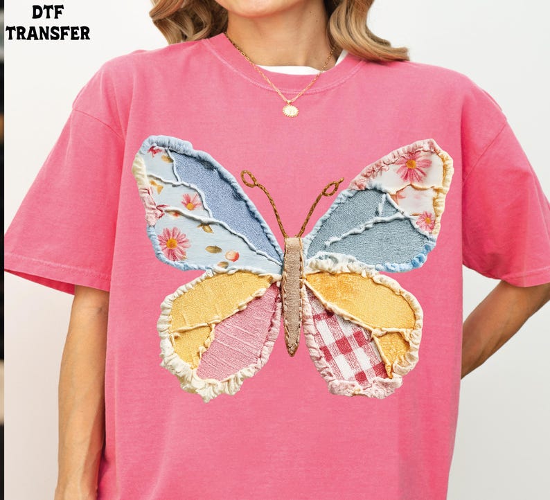 May include: Pink t-shirt featuring a large, patchwork butterfly design. The butterfly has wings in shades of blue, yellow, pink, and white, with floral and gingham patterns. The text "DTF TRANSFER" is in the upper left corner.