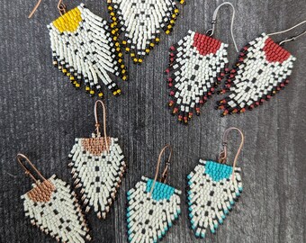 Fringe earrings in cream and black.