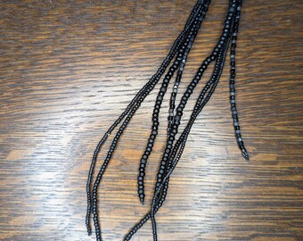 Long tassel seed bead earrings in shiny and matte black.