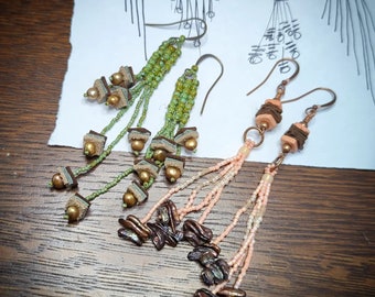 Seed bead tassel earrings with leather beads and pearls.