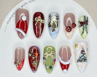 May include: A set of ten Christmas-themed nail tips. Designs include Santa hats, bows, reindeer, and Christmas trees. The nail tips are in various colors, including red, green, gold, and white. The words "Nail Tip" are printed on the bottom.