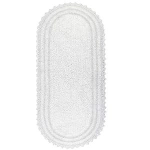 May include: A white, oval-shaped bath mat with a textured surface and a scalloped edge. The mat is designed to absorb water and provide a soft, comfortable surface for the feet.