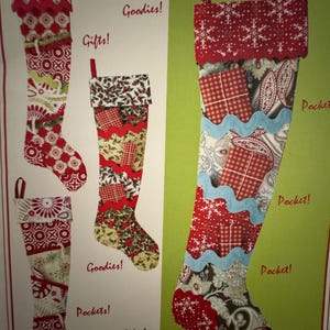 May include: Four fabric Christmas stockings featuring various patchwork patterns in red, white, and green. The stockings include decorative pockets, scalloped trim, and printed text labels such as Pockets!, Goodies!, Gifts!, and Video Demos Available Online!