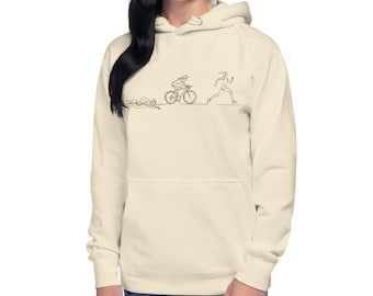 May include: A cream-colored hoodie with a black line drawing of a person swimming, biking, and running. The drawing represents the three sports in a triathlon.