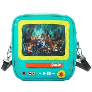 May include: A teal crossbody bag shaped like a retro television set. The screen displays a Scooby-Doo scene with the gang. The bag has a yellow frame, a red bar, and the words "Scooby-Doo!" on the front. It includes a black strap and silver hardware.