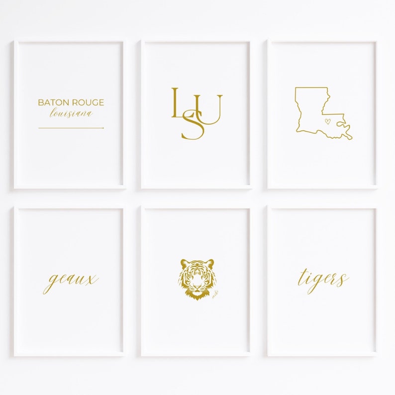 May include: Six framed art prints with white borders. The prints feature gold text and graphics on a white background. The prints include the words "Baton Rouge Louisiana", the letters "LSU", a Louisiana state outline, a tiger head, and the words "geaux" and "tigers".