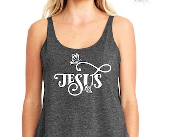May include: A charcoal gray tank top with a white graphic of the word "JESUS" in a cursive font with butterfly accents.