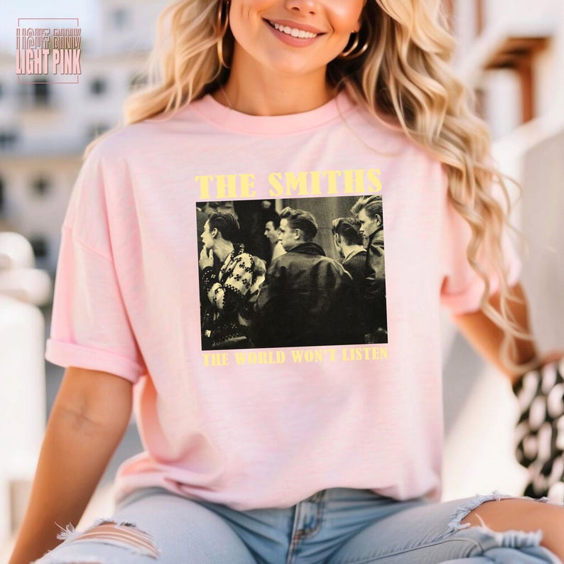 May include: A pink t-shirt with a black and white image of a band, The Smiths, with the text "The World Won't Listen".