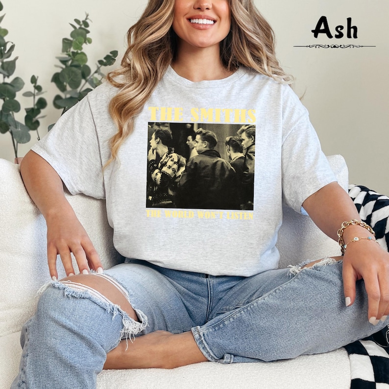 May include: A gray t-shirt with a black and white image of a band, The Smiths, with the text "The World Won't Listen".