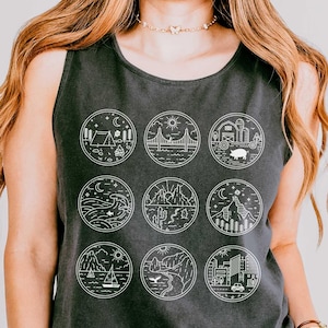 May include: Dark gray tank top with nine circular nature-themed illustrations in white. The illustrations include a tent, bridge, pig, waves, cactus, mountain, sailboat, bird, and city. The top has the text "UNISEX SIZING" at the top.