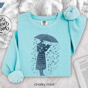CHALKY MINT folded flat lay sweatshirt styled on plush blanket with reading accessories, perfect for winter classroom or library lounge vibes