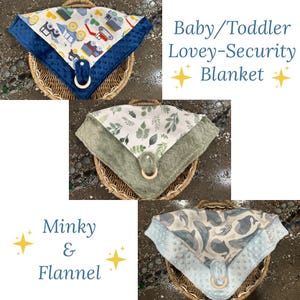 May include: Three baby security blankets with minky and flannel fabric. One has a construction vehicle pattern, another has a leaf pattern, and the third has a whale pattern. Each blanket has a wooden ring and a textured border. The text reads "Baby/Toddler Lovey-Security Blanket" and "Minky & Flannel".