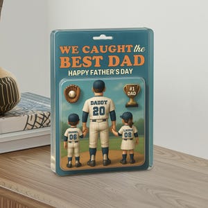 May include: A Father's Day gift featuring a baseball-themed design. The image includes a baseball glove, a trophy, and a family of three in baseball uniforms. The text reads "WE CAUGHT the BEST DAD HAPPY FATHER'S DAY."