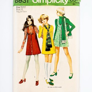 May include: Vintage Simplicity sewing pattern envelope. The cover features illustrations of three young women in 1970s mini-length dresses. The envelope is white with green and black text, including the pattern number, size, and price.