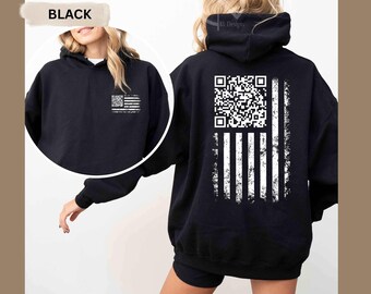 May include: Black hoodie with a distressed American flag design. The flag features a QR code in the upper left corner and white stripes. The hoodie has a front pocket and a hood. The word "BLACK" is in a banner in the upper left corner.