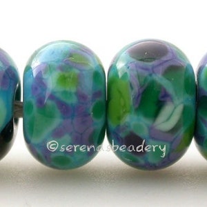 May include: Four glass beads with a swirling pattern of green, blue, purple, and white.